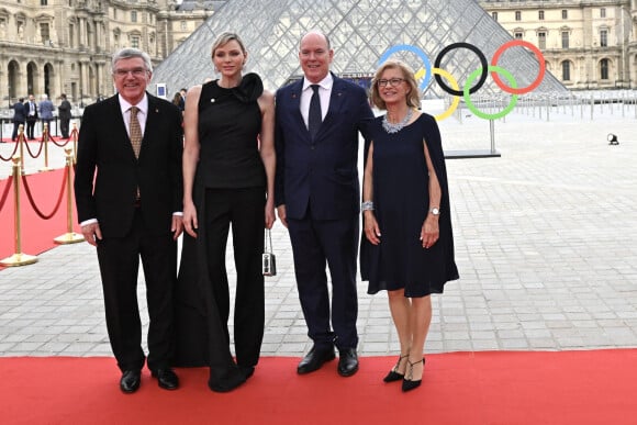 President of the International Olympic Committee (IOC) Thomas Bach (L) and his wife Claudia Bach (R) pose with Prince Albert II of Monaco and his wife Charlene, Princess of Monaco upon their arrival at the Pyramide du Louvre, designed by Ieoh Ming Pei, to attend a gala dinner hosted by the International Olympic Committee (IOC) and the French Presidency at the Louvre Museum in Paris, on the eve of the opening ceremony of the Paris 2024 Olympic Games, on July 25, 2024. Photo by Jeanne Accorsini/Pool/ABACAPRESS.COM