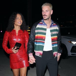 Los Angeles, CA - Christina Milian est arrivée au dîner dans une robe rouge à imprimé peau de serpent avec son mari Matt Pokora au Catch Steak LA à West Hollywood.