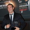 Jean Dujardin reçoit son prix d'homme de l'année lors de la soirée GQ des hommes de l'année 2011 au Ritz à Paris le 18 janvier 2012