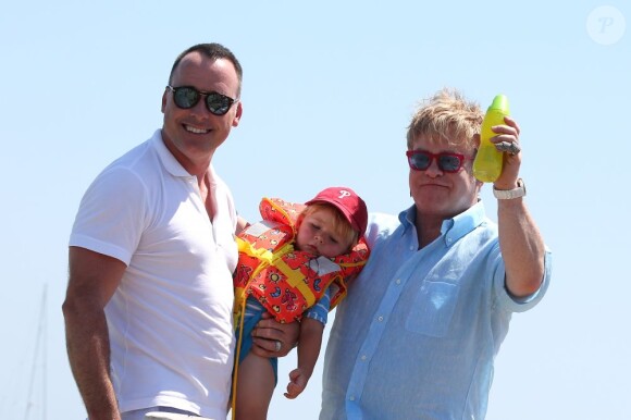Elton John et David Furnish, avec leur fils Zachary à Saint-Tropez, le 8 août 2012.