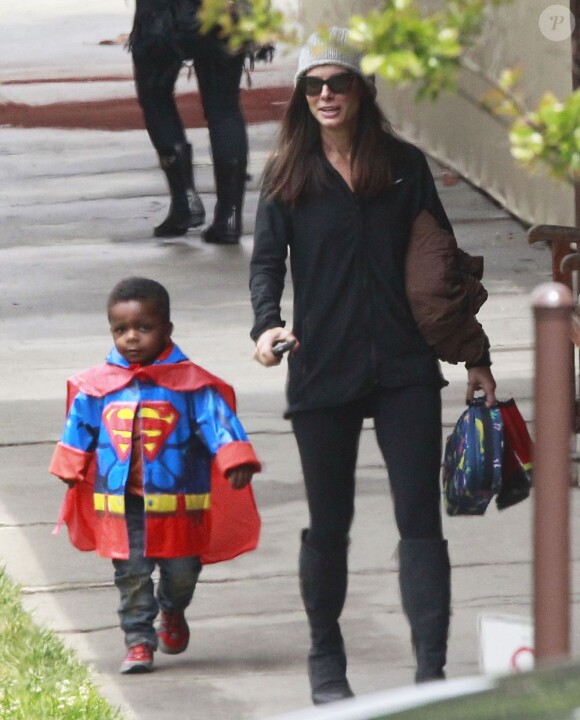 La belle Sandra Bullock a reçu des fleurs de son fils Louis, habillé en Superman à la sortie de l'école à Los Angeles, le 6 mai 2013.