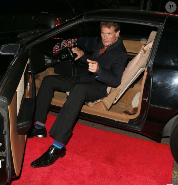 David Hasselhoff pose dans la voiture de sa serie "K2000" lors d'une soiree sur le theme des annees 80 a Londres le 5 juillet 2013  David Hasselhoff makes personal appearance at 80s themed Essex bar.But when he sees his knight rider car he has to get in it but then has a job to get out car to low down06/07/2013 - Londres