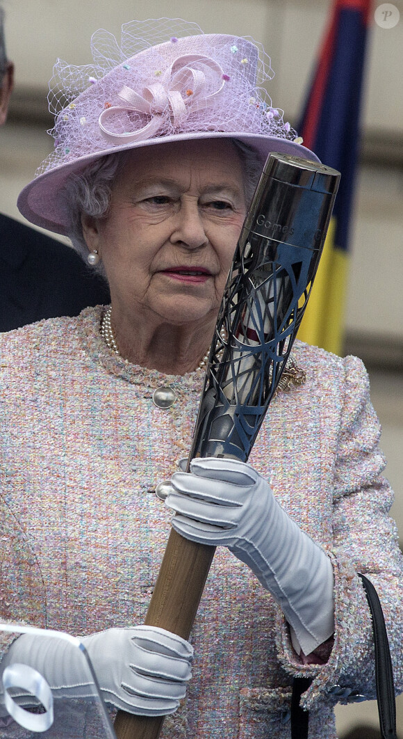 Queen Elizabeth II places her message to the Commonwealth Games in the Commonwealth Games Baton during its launch ceremony at Buckingham Palace in London, UK on October 9, 2013. Photo by Richard Pohle/The Times/PA Wire/ABACAPRESS.COM09/10/2013 - London