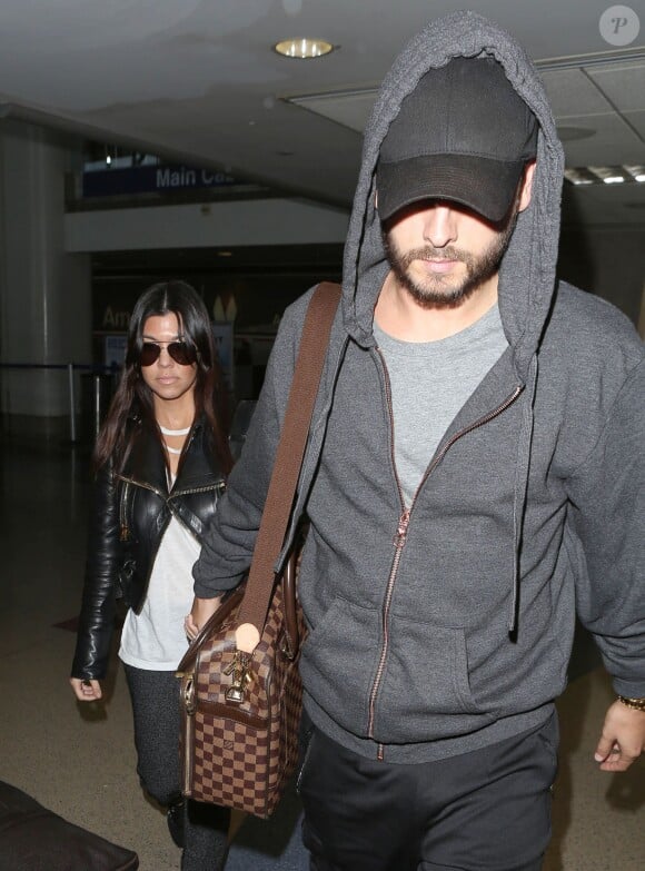 Kourtney Kardashian et Scott Disick arrivent à l'aéroport de Los Angeles, le 3 decembre 2013.