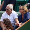 Dominique Strauss Kahn et sa compagne Myriam L'Aouffir au tournoi de Roland-Garros le 8 juin 2013.