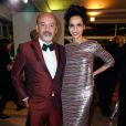 Christian Louboutin et Farida Khelfa lors du Dîner de la mode pour le Sidaction au Pavillon d'Armenonville à Paris, le 23 janvier 2014.