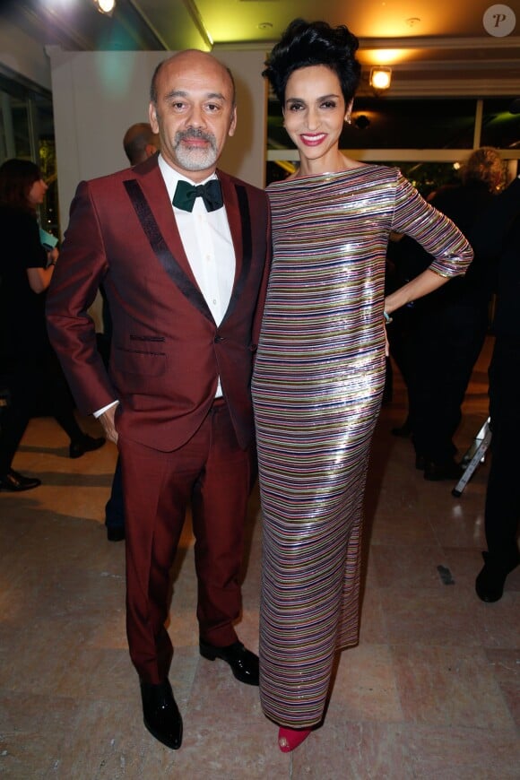 Christian Louboutin et Farida Khelfa lors du Dîner de la mode pour le Sidaction au Pavillon d'Armenonville à Paris, le 23 janvier 2014.