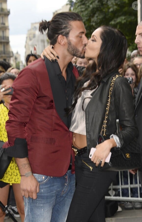 Nabilla et Thomas, stars de l'émission Les Anges de la Télé-Réalité 5, s'embrassent à l'entrée de l'atelier de Jean-Paul Gaultier. Paris, le 3 juillet 2013.