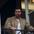 Exclusif - Drake salue ses fans de la fenêtre du premier étage de la boutique Colette, à Paris. Le 24 février 2014.