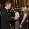 Le prince William discutant avec Kate Moss, le 13 mai 2014 au château de Windsor, lors d'une soirée de bienfaisance au profit du Royal Marsden Hospital dont le duc de Cambridge est le président, organisée avec Ralph Lauren.