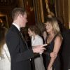 Le prince William parlant avec Kate Moss, le 13 mai 2014 au château de Windsor, lors d'une soirée de bienfaisance au profit du Royal Marsden Hospital dont le duc de Cambridge est le président, organisée avec Ralph Lauren.