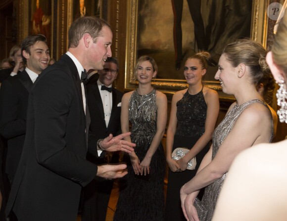 Le prince William face à Cara Delevingne, le 13 mai 2014 au château de Windsor, lors d'une soirée de bienfaisance au profit du Royal Marsden Hospital dont le duc de Cambridge est le président, organisée avec Ralph Lauren.
