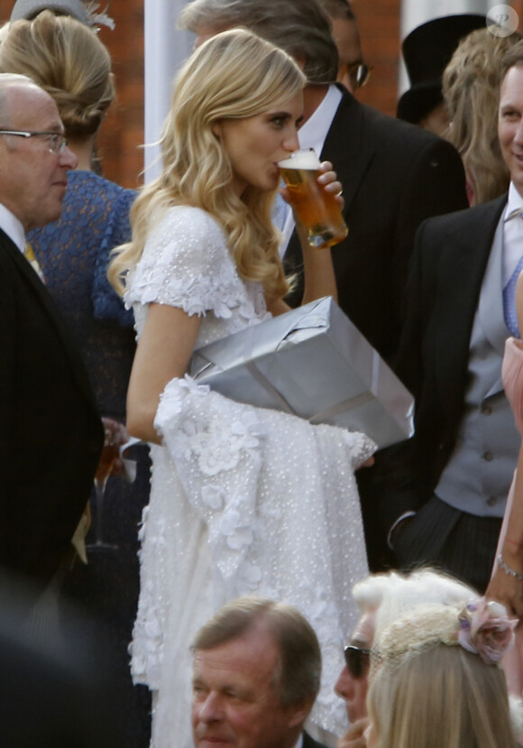 Poppy Delevingne enjoys a glas of beer as she speaks with Geri Halliwell and boyfriend Red Bull F1 boss Christian Horner at a reception in Kensington Gardens for Poppy Delevingne and James Cook's wedding, in London, UK on Friday May 16, 2014. Photo by XPosure/ABACAPRESS.COM17/05/2014 - London