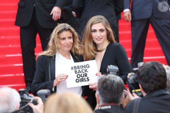 Lisa Azuelos et Julie Gayet (pancarte pour les lycéennes enlevées au Nigéria) lors de la montée des marches du film Saint Laurent et l'hommage au cinéma d'animation au Festival de Cannes le 17 mai 2014