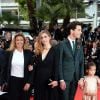 Julie Gayet, Mika et la fille de Salma Hayek, Valentina Pinault, lors de la montée des marches du film Saint Laurent et l'hommage au cinéma d'animation au Festival de Cannes le 17 mai 2014