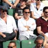 Jean Dujardin, Tahar Rahim et Yvan Attal à la finale homme des Internationaux de France de tennis de Roland Garros à Paris le 8 juin 2014.
