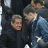 Louis Sarkozy et Nicolas Sarkozy au Stade de France pour un match du PSG en Coupe de la Ligue, le 19 avril 2014. 