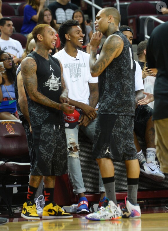 Chris Brown, Tyga et Nick Young lors du match de basket-ball caritatif Power 106 All-Star à l'USC Galen Center. Los Angeles, le 21 septembre 2014.