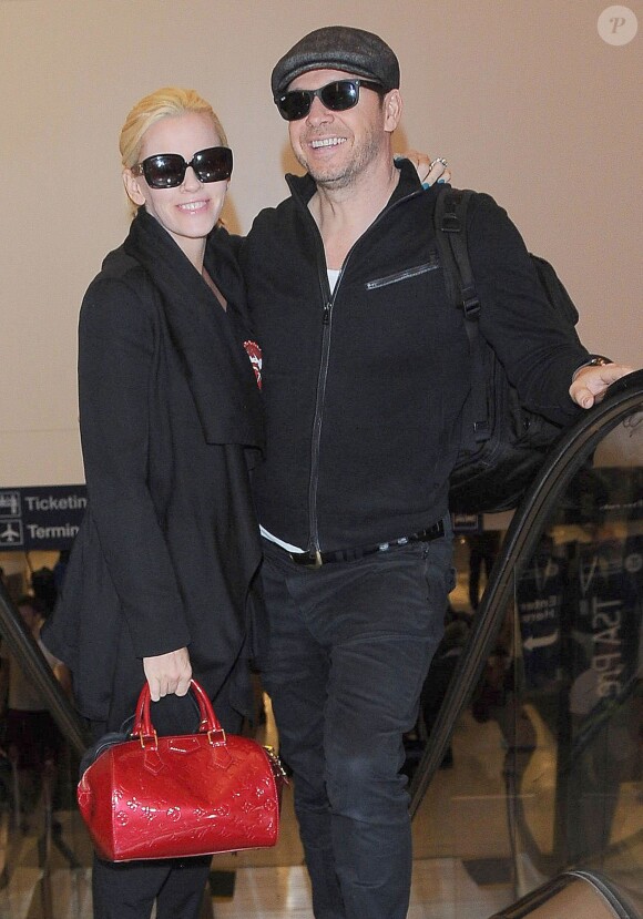 Jenny McCarthy et son mari Donnie Walhberg prennent un vol à l'aéroport de Los Angeles, le 28 septembre 2014.