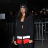 Rihanna, tout de Givenchy vêtue et chaussée de baskets Nike + R.T., assiste au défilé Givenchy automen-hiver 2014-15 à Paris. Le 2 mars 2014.