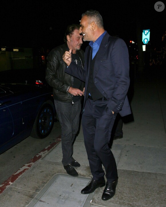 Johnny Hallyday et Christian Audigier au restaurant Mr Chow à Los Angeles le 23 janvier 2015.