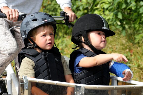 Les jumeaux Vincent et Josephine, avec son bras dans le plâtre, se font transporter à vélo. Le prince Frederik de Danemark, la princesse Mary et leurs enfants sont partis à vélo pour le centre équestre de Grasten le 24 juillet 2015, après la cérémonie de la relève de la garde.