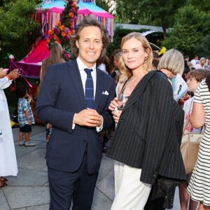 David Lauren (fils de Ralph Lauren) et Diane Kruger lors du défilé Polo Ralph Lauren (collection enfant automne-hiver 2015-2016) au zoo de Central Park. New York, le 5 août 2015.