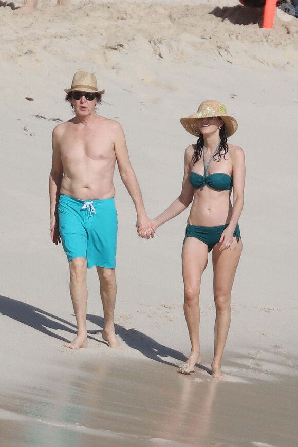 Sir Paul McCartney, 73, enjoys a romantic stroll on the beach with his stunning bikini-clad wife Nancy Shevell, 56, during St Barts getaway, December 27, 2015. Photo by ABACAPRESS.COM27/12/2015 - St Barthelemy