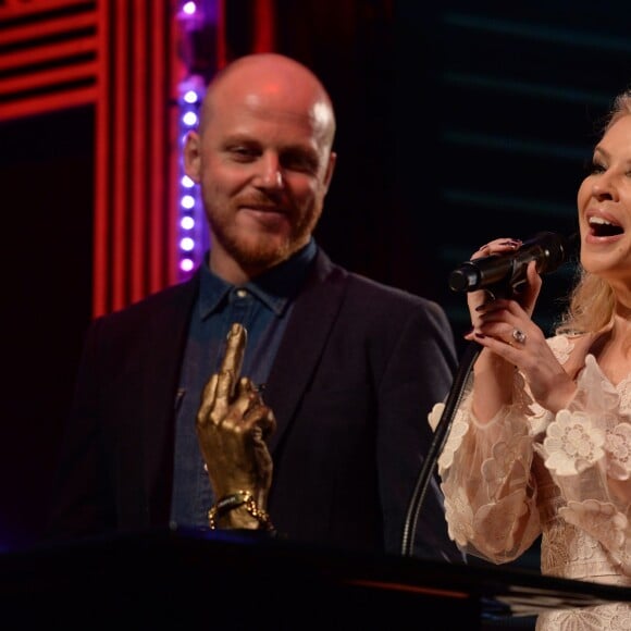 Le rédacteur du chef du magazine NME Mike Williams et Kylie Minogue sur la scène des NME Awards à l'O2 Brixton Academy à Londres, le 17 février 2016.