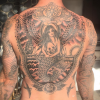 Adam Levine dévoile un cliché de son nouveau tatouage dans le dos en forme de sirène. Photo publiée sur Instagram, le 25 février 2016.
