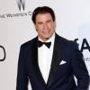 John Travolta au Photocall de la soirée "AmfAR's 21st Cinema Against AIDS" à l'Eden Roc au Cap d'Antibes lors du 67ème festival du film de Cannes, le 22 mai 2014.