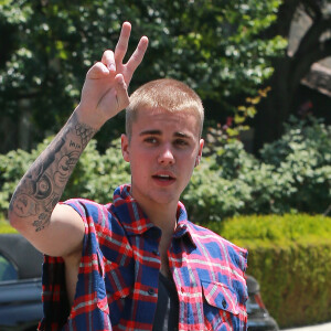 Justin Bieber salue et pose pour les photographes dans les rues de Los Angeles, le 27 mai 2016