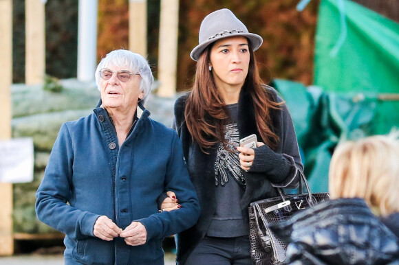 Exclusif - Bernie Ecclestone se promène avec sa femme Fabiana Flosi et des amis dans les rues de Gstaad pendant leurs vacances. Le 22 décembre 2014