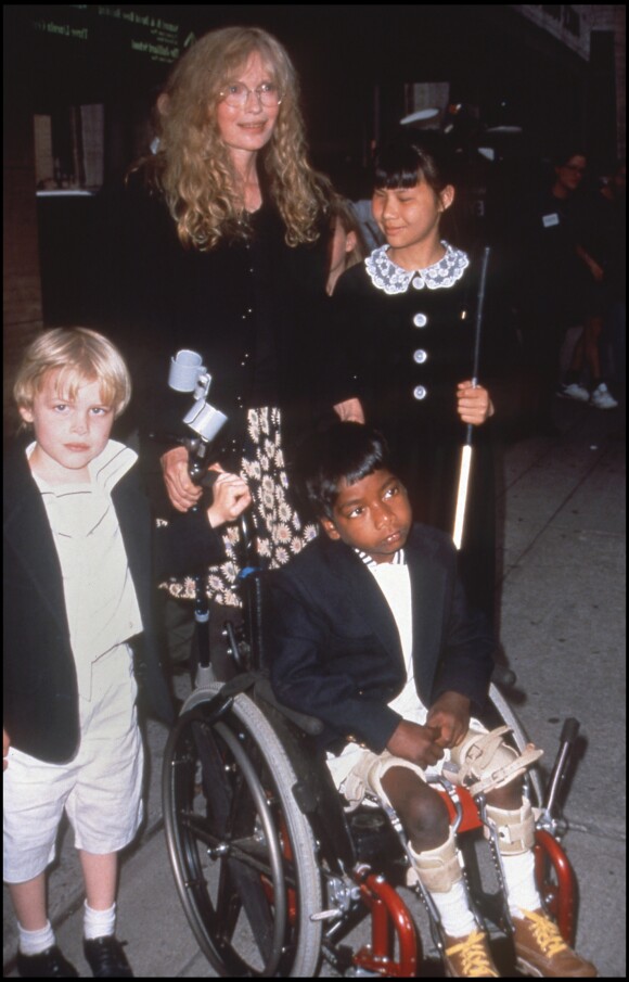 Mia Farrow avec ses enfants, dont Thaddeus en chaise roulante, en 1996.
