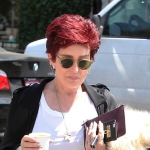 Sharon Osbourne se balade en buvant son café et son chien dans le bras à West Hollywood, Californie, Etats-Unis, le 8 août 2016.