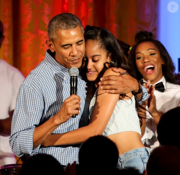 Barack Obama serrant dans ses bras sa fille Malia pour l'anniversaire de la jeune femme lors d'une fête célébrée à la Maison Blanche à Washington le 4 juillet 2016