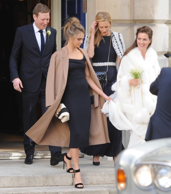 Cara et sa soeur Poppy Delevingne au Mariage de Chloe Delevingne et Edward Grant à Londres. Le 7 février 2014
