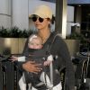 Nina Dobrev arrive à l'aéroport de LAX avec le bébé d’amis en Porte-bébé kangourou à Los Angeles, le 6 mars 2017 © CPA/Bestimage