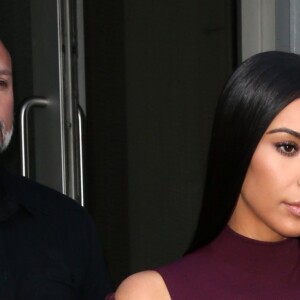 Kim Kardashian habillée de la tête aux pieds en bordeaux avec un haut très transparent à la sortie d'un immeuble à New York, le 15 février 2017