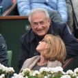Dominique Strauss-Kahn et sa compagne Myriam L'Aouffir assistent au 8e sacre de Rafael Nadal lors des Internationaux de France a Roland Garros à Paris le 9 juin 2013.