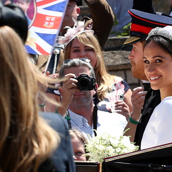 Le prince Harry et Meghan Markle, duc et duchesse de Sussex, ont effectué une procession dans le landau Ascot après leur mariage en la chapelle St George à Windsor le 19 mai 2018, à la rencontre du public dans toute la ville de Windsor et le long du Long Walk.