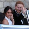 Le prince Harry, duc de Sussex, et Meghan Markle, duchesse de Sussex, habillée d'une robe Stella McCartney et portant une bague sertie d'une aigue-marine ayant appartenu à Lady Diana, quittant le château de Windsor après la réception offerte par Elizabeth II pour rejoindre à bord d'une Jaguar E-Type Concept Zero immatriculée "190518" Frogmore House où avait lieu la réception de leur mariage, le 19 mai 2018.