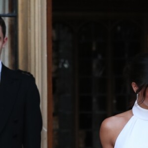Le prince Harry, duc de Sussex, et Meghan Markle, duchesse de Sussex, habillée d'une robe Stella McCartney et portant une bague sertie d'une aigue-marine ayant appartenu à Lady Diana, ont quitté le château de Windsor après la réception offerte par Elizabeth II pour rejoindre à bord d'une Jaguar E-Type Concept Zero immatriculée "190518" Frogmore House où avait lieu la réception de leur mariage, le 19 mai 2018.