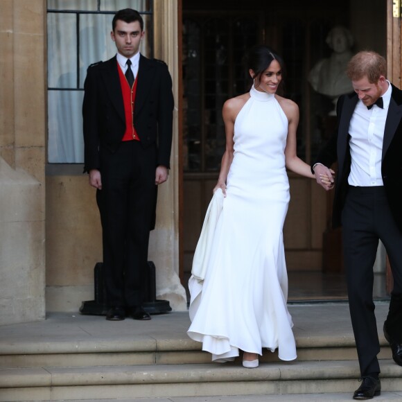 Le prince Harry, duc de Sussex, et Meghan Markle, duchesse de Sussex, habillée d'une robe Stella McCartney et portant une bague sertie d'une aigue-marine ayant appartenu à Lady Diana, ont quitté le château de Windsor après la réception offerte par Elizabeth II pour rejoindre à bord d'une Jaguar E-Type Concept Zero immatriculée "190518" Frogmore House où avait lieu la réception de leur mariage, le 19 mai 2018.