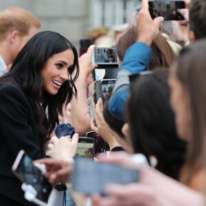 Le prince Harry, duc de Sussex et sa femme Meghan Markle, duchesse de Sussex saluent la foule lors de leur visite au collège de la trinité à Dublin le 11 juillet 2018