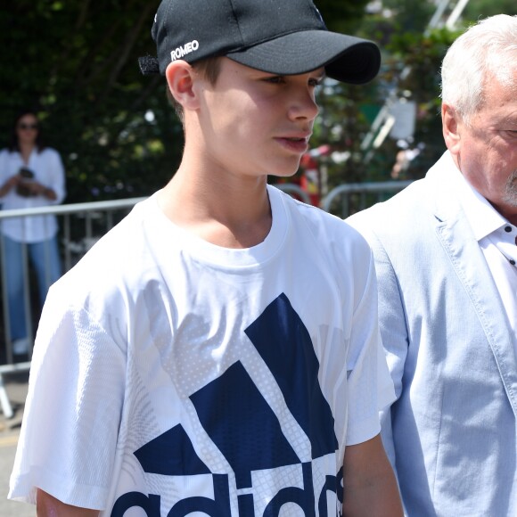 Romeo Beckham et son grand-père (le père de Victoria Beckham) Anthony Adams arrivent au stade de Wimbledon à Londres, le 11 juillet 2018.