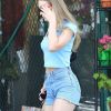Exclusif - Lily-Rose Depp fait des courses avec une amie dans les rues de Los Angeles, le 12 août 2018  For germany call for price Exclusive - Lily-Rose Depp opts for a swimsuit for a bra while shopping for groceries with a friend. Lily-Rose looks great in the light blue t-shirt, denim shorts, and red flats. 12th august 201812/08/2018 - Los Angeles