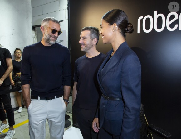 Vincent Cassel, Paul Surridge, Tina Kunakey au défilé Roberto Cavalli lors de la Fashion Week de Milan prêt-à-porter printemps/été 2019 le 22 septembre 2018.