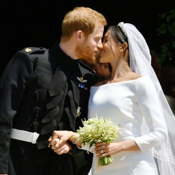 Le prince Harry et Meghan Markle (en robe de mariée Givenchy), duc et duchesse de Sussex, échangeant un baiser à la sortie de chapelle St. George au château de Windsor après leur mariage le 19 mai 2018.