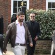 George Michael quitte son domicile avec son petit-ami Fadi Fawaz, à Londres, le 14 mars 2012.